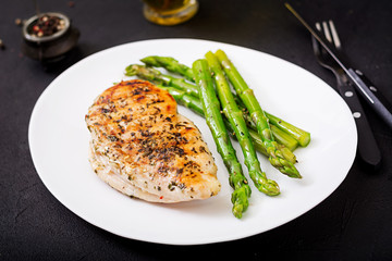 Chicken fillet cooked on a grill and garnish of asparagus