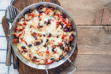Baked rice casserole with different kinds of beans, cheese and paprika, horizontal, top view, copy...