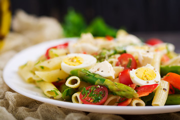 Salad - penne pasta with asparagus, tomatoes, quail eggs, mozzarella