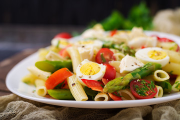 Salad - penne pasta with asparagus, tomatoes, quail eggs, mozzarella