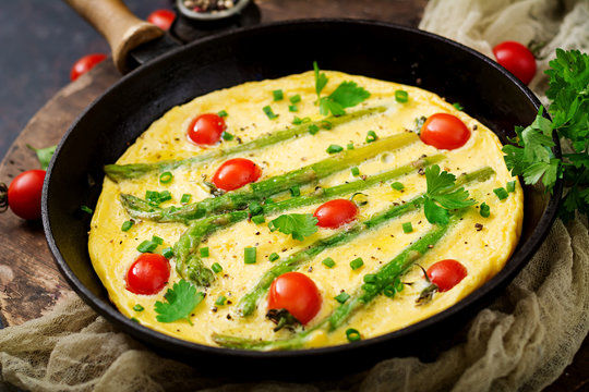 Omelette (omelet) with tomatoes, asparagus and green onions