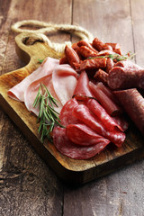 Marble cutting board with prosciutto, bacon, salami and sausages