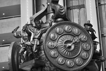 City clock with decor elements in the form of statuettes