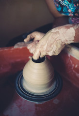 Work in a pottery workshop, womans hands creating ceramics. 