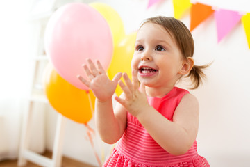 happy baby girl on birthday party at home