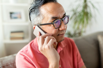 close up of asian man calling on smartphone