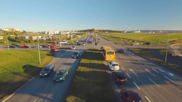 evening car traffic in Reykjavik, road leading to Perlan view from bridge in autumn, sunny weather