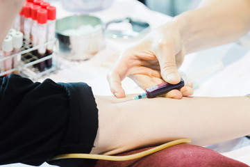 Nurses collect blood from patients by drilling their arms for examination.