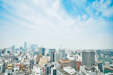 Business concept - panoramic modern city skyline bird eye aerial view with spiral tower and midland square under dramatic cloud and morning bright blue sky on Nagoya TV Tower in Nagoya, Japan