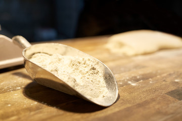 flour in bakery scoop on kitchen table