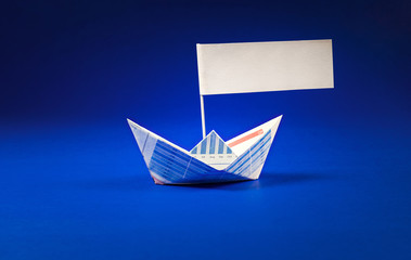 Boat paper graph with  flag on blue ocean.you can put some.message for your business concept.