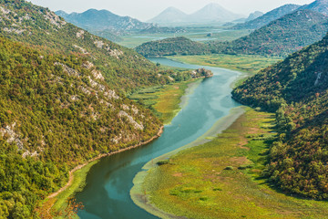 Fototapeta na wymiar Canyon Crnojevica river near the Skadar lake coast. One of the most famous views of Montenegro. River makes a turn between the mountains and flows backward.