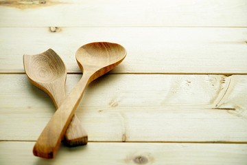 wooden spoons on the wooden background,different wooden kitchen tools on the table with copy space