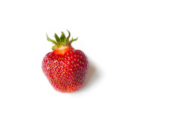One Fresh Strawberry isolated on white background. Freshly picked ripe red strawberry.