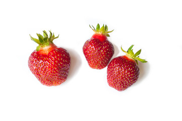 Three Fresh Strawberry isolated on white background. Freshly picked ripe red strawberries.