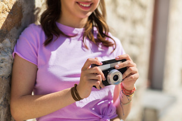 close up of woman with vintage camera outdoors