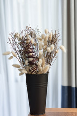 Beautiful dried flower bouquet in black vasa,bedroom interior