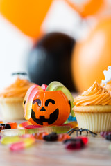 halloween party decorated cupcakes on wooden table