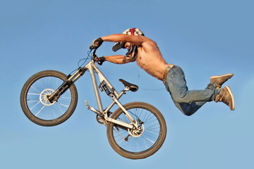 Biker on the bike in the air in about the time of the trick