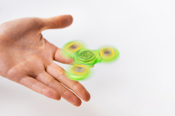 close up of hand playing with fidget spinner