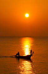 Fishermen are fishing during sunrise. Start of the day