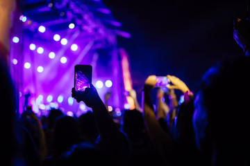 Obraz na płótnie Canvas People Taking Photos At A Music Concert