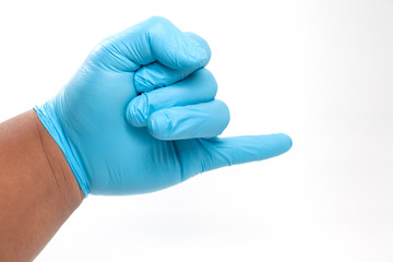 hand in blue glove showing promising hand sign