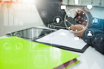 businessman working with business documents on office table with digital tablet computer and graph finance diagram in the background