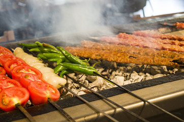 Adana kebab and tomatoes and peppers barbecued