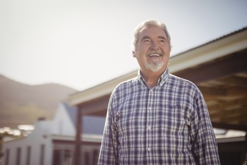 Smiling senior man looking at the sky