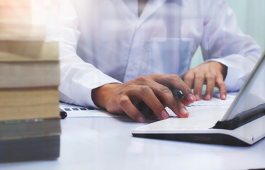 businessman working with business documents on office table with digital tablet computer 