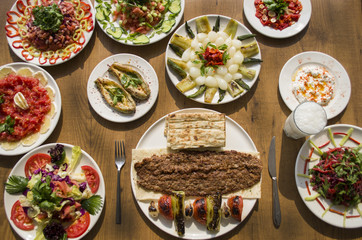 Kebab; healthy and fresh salad varieties and appetizer on wooden table