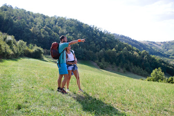 Couple looking landscape on the mountain