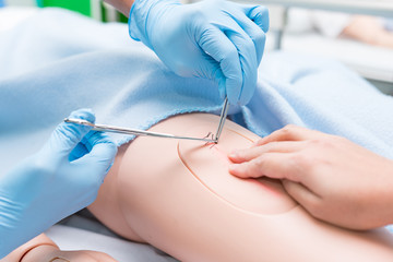 Nursing student were trained how to stitch off with suture wound of the patient. She practice...