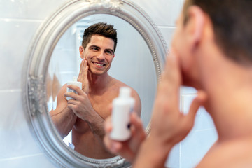 Happy handsome man shaving