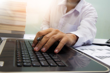 Close up business man hand working on screen laptop computer on the white desk as concept