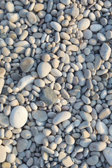 Closeup of pebble stones texture on a sunny day