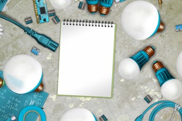 Electric collage on synthetics on concrete with blank notebook paper and cables, soldering irons,...