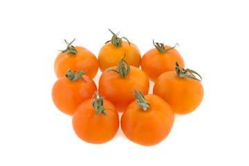 small orange tomatoes on a white background
