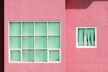 glass window at pink concrete building