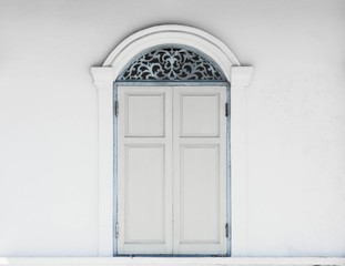 white antique wood window at white concrete building