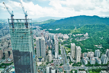 Business concept for real estate and corporate construction : panoramic modern city bird eye view with morning cloudy grey sky from 101 building in Taipei, Taiwan