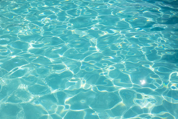 Fototapeta na wymiar Close up of shiny blue water of swimming pool
