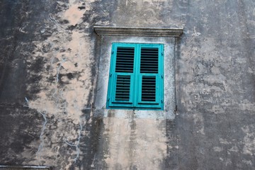 blue old wooden window on old wall 