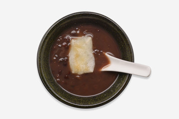 Hot sweet red bean with Japanese rice cake (Oshiruko) in black bowl on white background