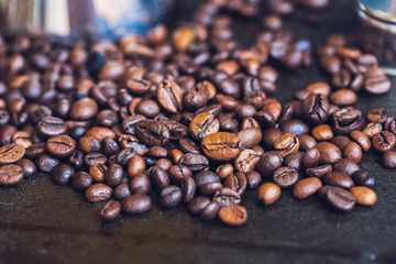 Details of a metal coffee maker in coffee beans. Retro. Macro Vintage toning