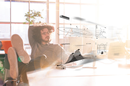 Businessman Sitting With Legs On Desk