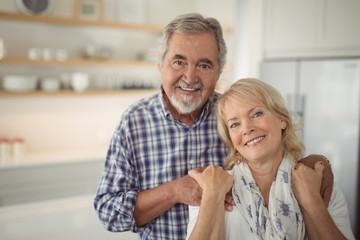 Senior couple hugging each other at home