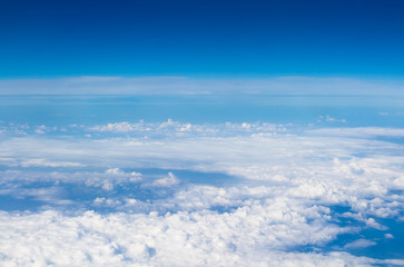 Fototapeta na wymiar blue sky high view from airplane clouds shapes