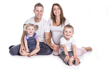 Happy family with two kids on studio white background
